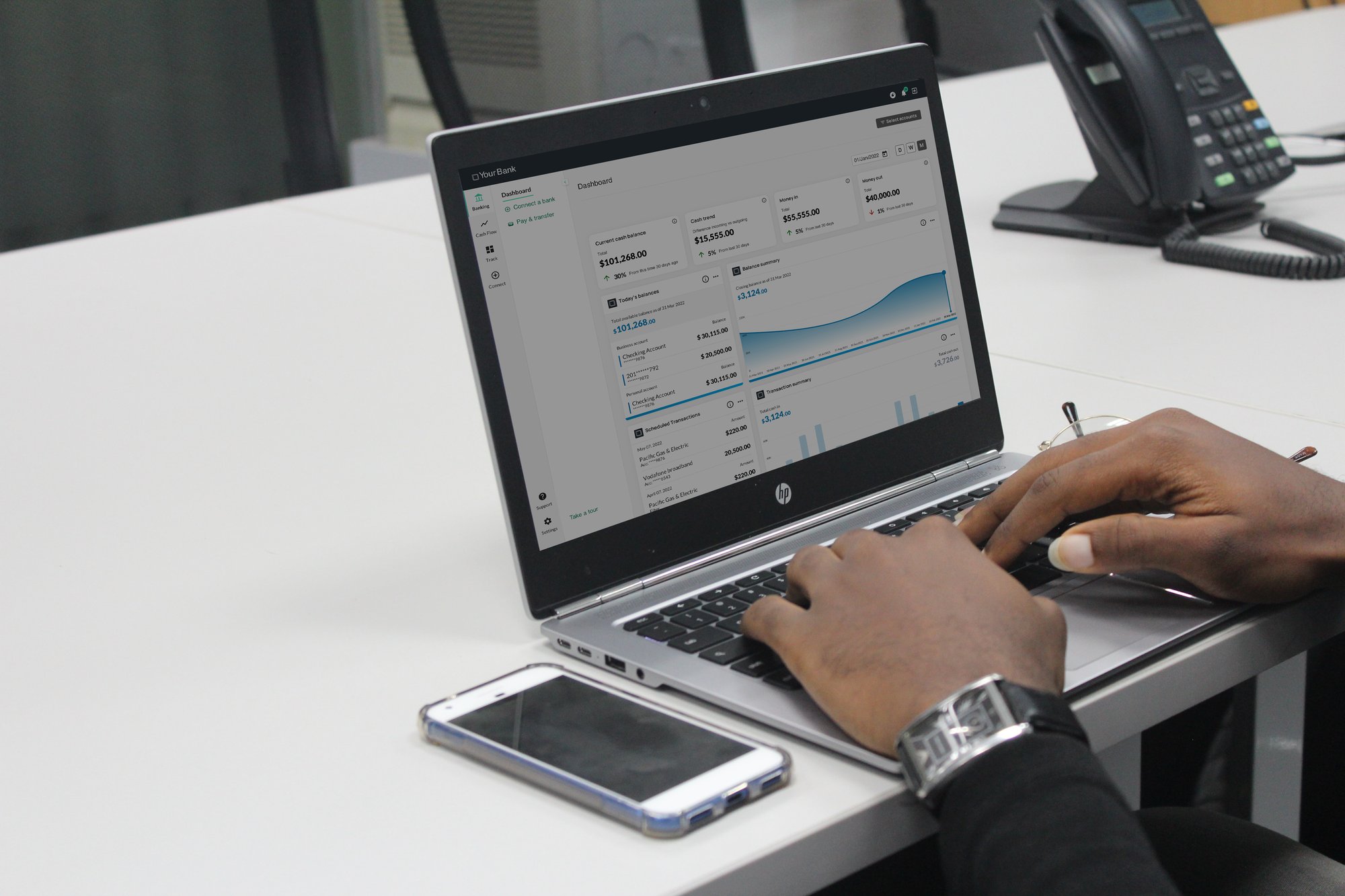 Hands working on laptop with 9Spokes Banking screen Hands working on laptop with 9Spokes Banking screen