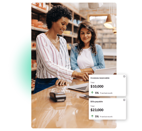 Two female SMB staff looking at laptop and 9Spokes product screens